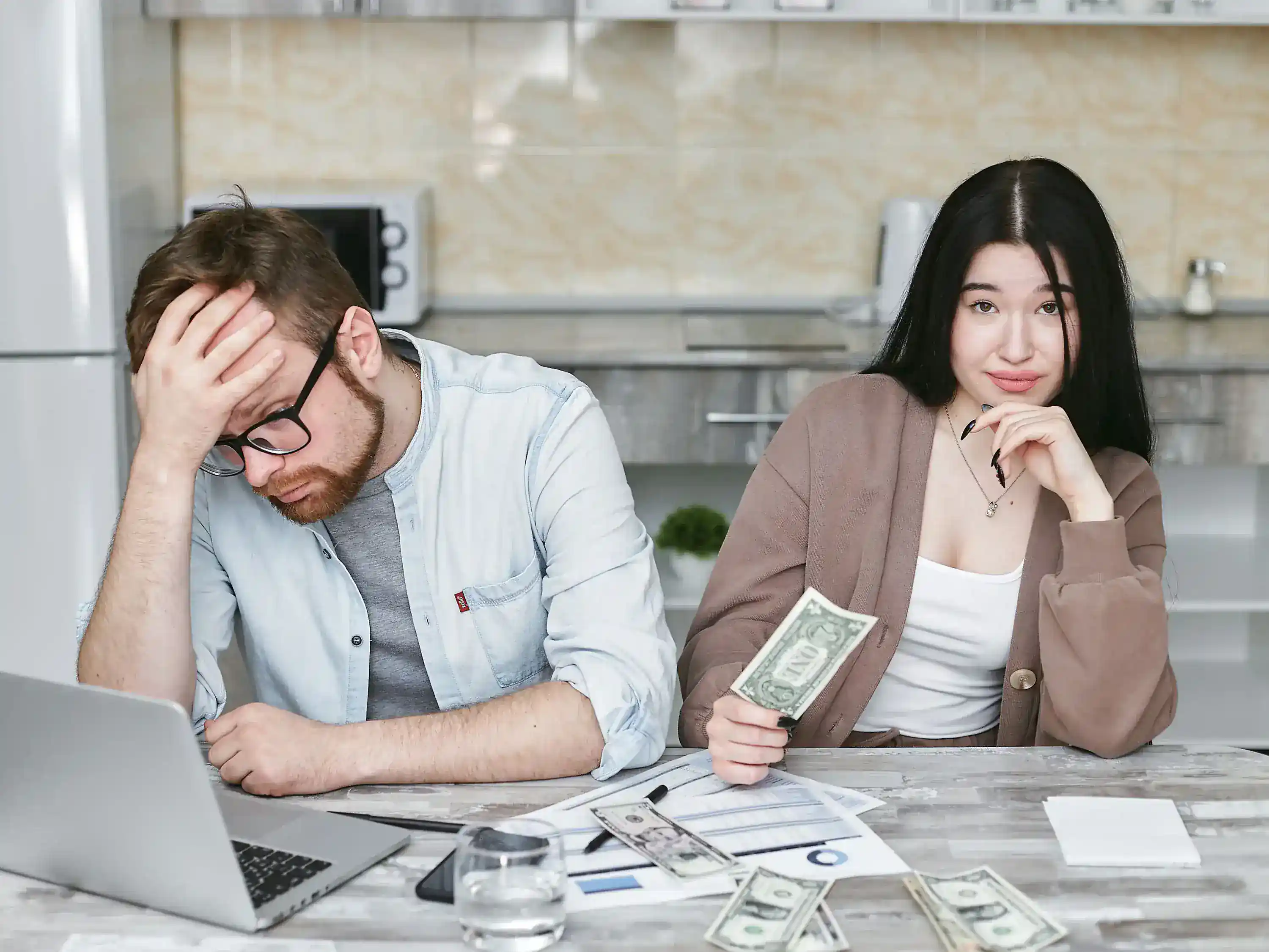 Household reviewing bills and cash during a period of financial stress